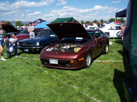 1972 Ford Ranchero - A maroon coupe, possibly a Porsche 944, is displayed with its hood open at an outdoor car show.
