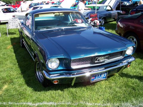 1972 Ford Ranchero - A blue coupe with a distinctive grille and chrome bumper sits on a grassy field.