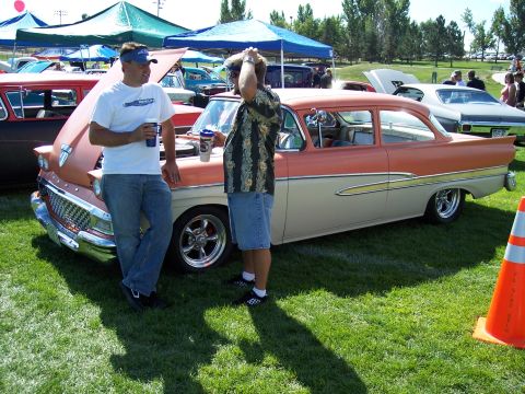 1972 Ford Ranchero - Two men stand by a classic two-tone Ford sedan at an outdoor car show.