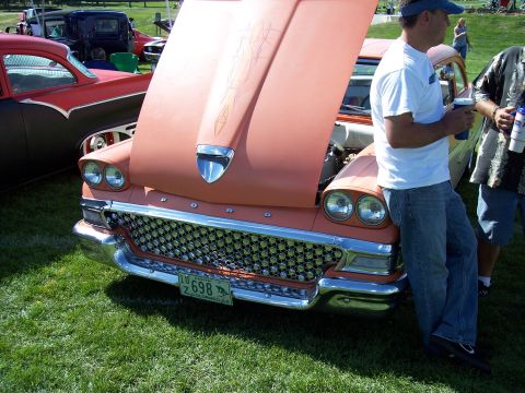 1972 Ford Ranchero - A classic Ford Fairlane with a distinctive grille and pinstripe detailing on the hood is displayed at an outdoor event.