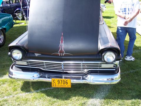 1972 Ford Ranchero - A customized 1957 vehicle with a matte black finish and red pinstripes is displayed with its hood open.