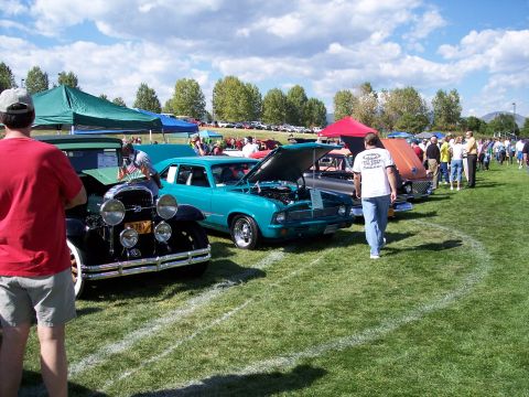 1972 Ford Ranchero - Several cars are displayed on a grassy field under a partly cloudy sky at an outdoor event.