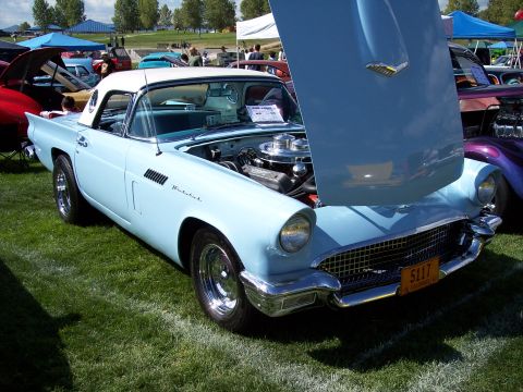 1972 Ford Ranchero - A light blue 1957 Ford Thunderbird convertible is displayed with its hood open at an outdoor car show.