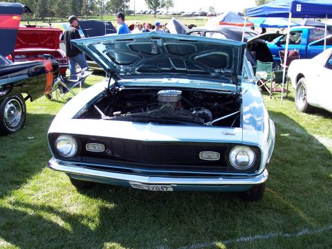 1972 Ford Ranchero - A light blue 1969 Chevrolet Camaro is displayed with its hood open at an outdoor car show.