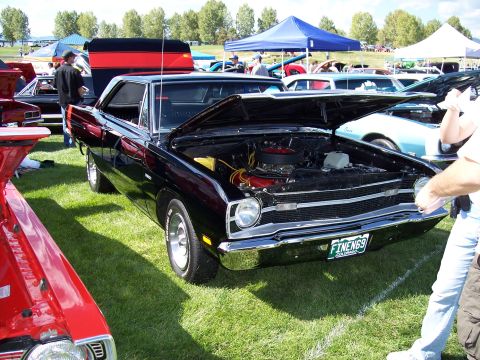1972 Ford Ranchero - A black 1969 Dodge Dart coupe is displayed with its hood open at an outdoor car show.