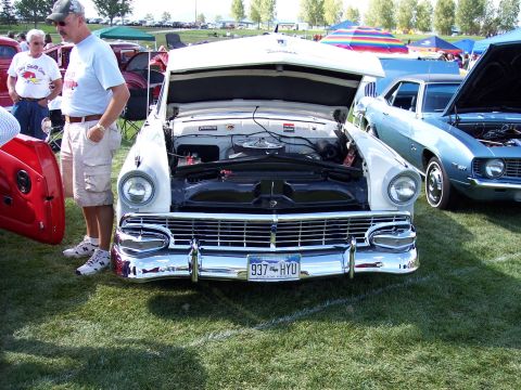 1972 Ford Ranchero - A white 1950s Ford Fairlane is displayed with its hood open at an outdoor car show.