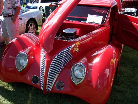 1972 Ford Ranchero - A red custom hot rod, likely from the late 1930s, displayed with its hood and door open.