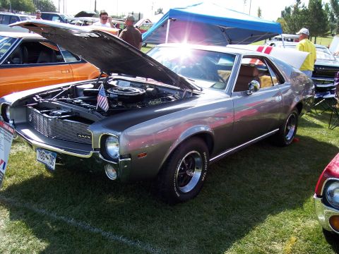 1972 Ford Ranchero - This 1969 AMC AMX is displayed with its hood open, revealing the engine compartment adorned with a small American flag.