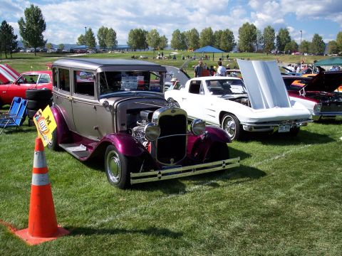 1972 Ford Ranchero - Several classic cars are displayed on a grassy field under a partly cloudy sky at an outdoor event.