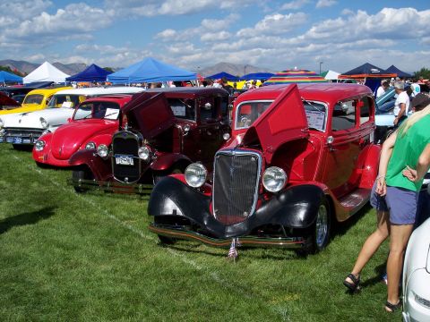 1972 Ford Ranchero - A red 1933 Ford sedan is displayed at an outdoor car show with its hood open.