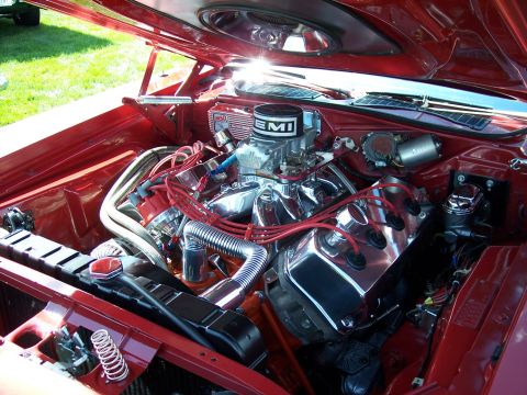 1972 Ford Ranchero - The engine bay of a classic car features a polished V8 engine with custom red spark plug wires and an aftermarket air cleaner.
