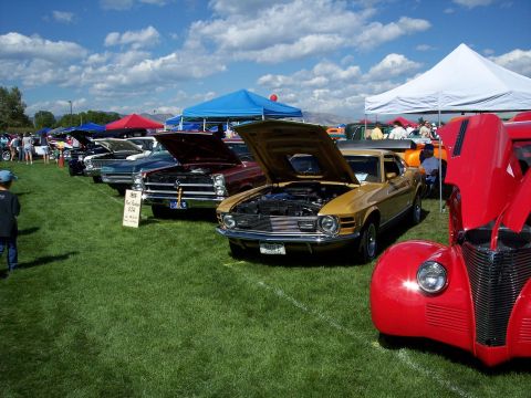 1972 Ford Ranchero - A gold coupe, likely from the 1970s, is displayed with its hood open at an outdoor car show.
