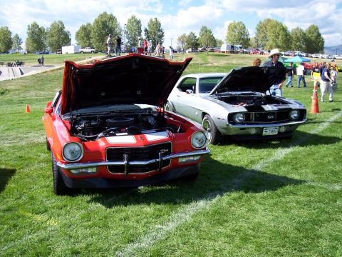 1972 Ford Ranchero - A red 1970 Chevrolet Camaro SS is displayed with its hood open at an outdoor car show.