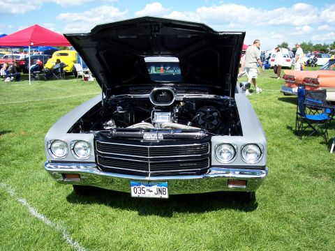 1972 Ford Ranchero - Front view of a 1970 Chevrolet Chevelle SS at a car show, engine exposed under the open hood.