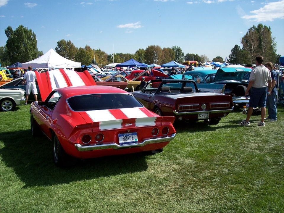 Red 1970 Chevrolet Camaro Z28 with white stripes on hood and trunk, license plate ROADZ
