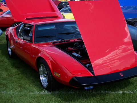 1972 Ford Ranchero - A red 1972 De Tomaso Pantera is displayed with its hoods open at an outdoor car show.