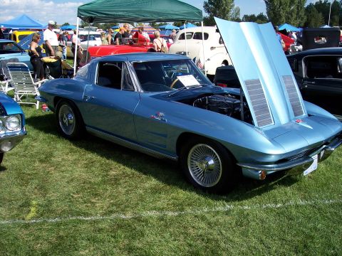 1972 Ford Ranchero - A blue 1963 Corvette Sting Ray coupe is displayed with its hood open at an outdoor car show.