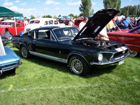 1972 Ford Ranchero - A dark green 1968 Ford Mustang GT350 is displayed with its hood open at an outdoor car show.