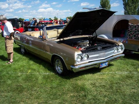 1972 Ford Ranchero - A 1965 Chevrolet Chevelle Malibu convertible is displayed with its hood open at an outdoor car show.