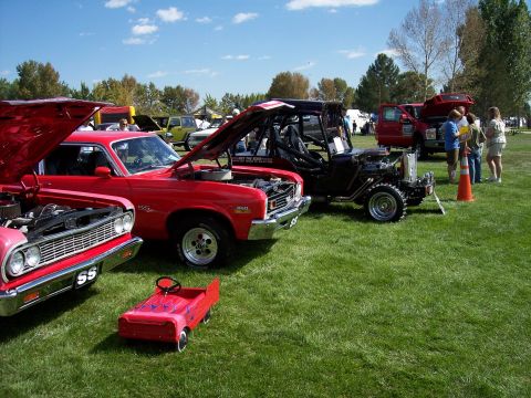 1972 Ford Ranchero - Several cars are displayed on a grassy field under a blue sky with scattered clouds.