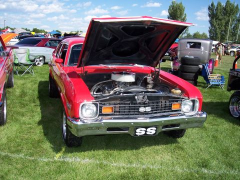 1972 Ford Ranchero - This red 1970s Chevrolet Nova SS is displayed with its hood open at an outdoor car show.