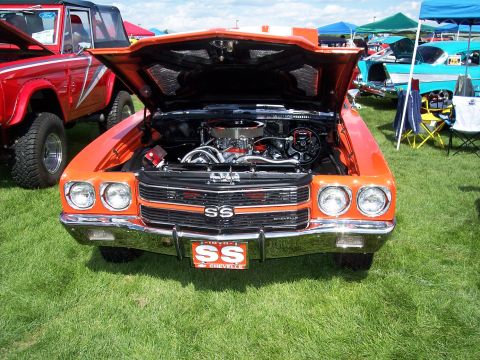 1972 Ford Ranchero - A 1970 Chevrolet Chevelle SS is displayed with its hood open, the engine bay at an outdoor car show.