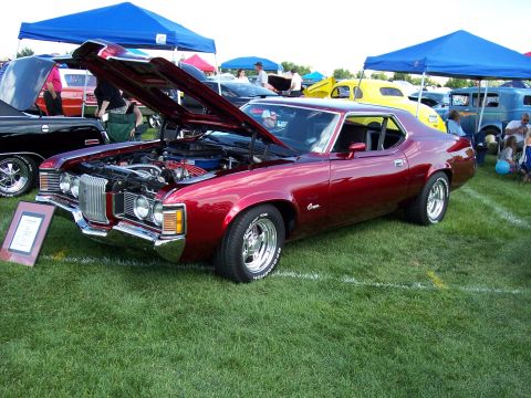 1972 Ford Ranchero - A red 1970-1973 Mercury Cougar is displayed with its hood open at an outdoor car show.
