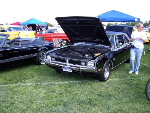 1972 Ford Ranchero - A black 1972 Dodge Dart Swinger is displayed with its hood open at an outdoor car show.