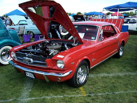 1972 Ford Ranchero - This 1965 Ford Mustang coupe is displayed with its hood and trunk open at an outdoor car show.