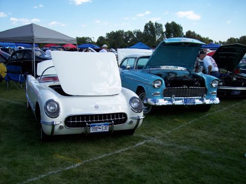 1972 Ford Ranchero - A white 1955 Chevrolet Bel Air convertible is parked on grass with its hood open, next to a blue car.