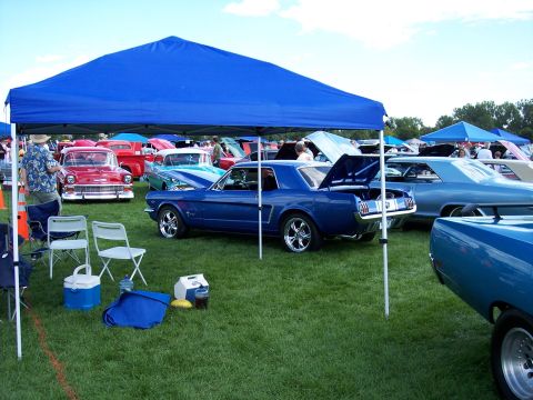 1972 Ford Ranchero - Several classic cars are displayed on a grassy field under tents at an outdoor car show.
