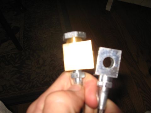 1996 Ford Bronco - Close-up of two brake line fittings being held in a hand.