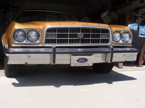 1973 Ford Ranchero - The front of a gold 1973 Ford Ranchero is visible, parked inside a garage.