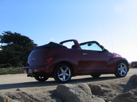 2005 Chrysler PT Cruiser - A maroon 2005 Chrysler PT Cruiser convertible is seen from a three-quarter front angle, parked outdoors on a sunny day.