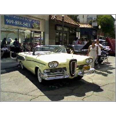 2007 Ford Ranchero - This yellow 1958 Edsel Pacer convertible is parked on a street with a building in the background.