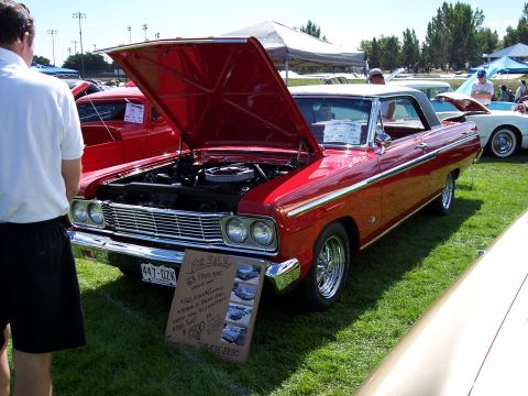 1972 Ford Ranchero - A red 1963 Ford Fairlane convertible is displayed with its hood open at an outdoor event.
