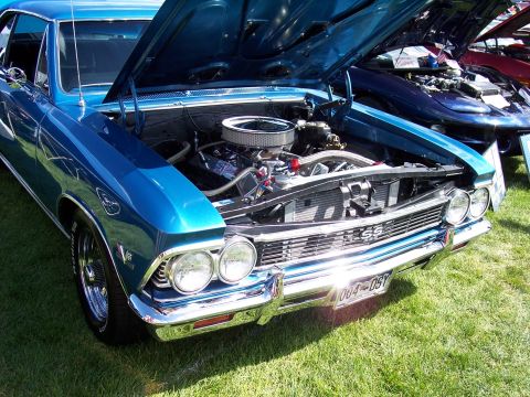 1972 Ford Ranchero - A blue 1966 Chevrolet Chevelle SS is displayed with its hood open, revealing the engine bay.