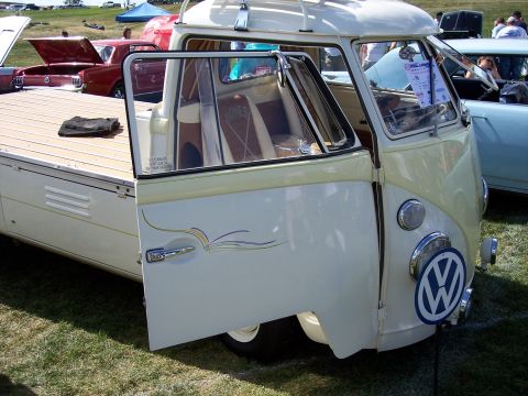 1972 Ford Ranchero - A vintage Volkswagen Type 2 pickup truck is displayed outdoors with its door open, revealing the interior and a wooden flatbed.