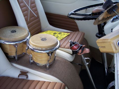 1972 Ford Ranchero - The interior of a vehicle is shown with bongo drums placed on the seats.