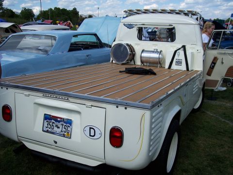 1972 Ford Ranchero - A white Volkswagen Type 2 pickup truck with a wooden bed is parked at an outdoor event, with another car visible to the left.