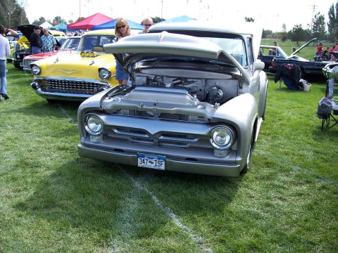 1972 Ford Ranchero - A silver 1956 Ford F-100 pickup truck is displayed with its hood open at an outdoor car show.