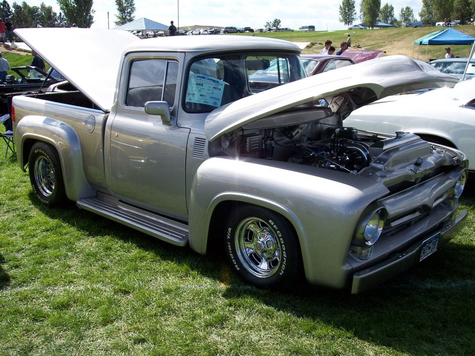 Silver 1956 Ford F-100 pickup truck with engine exposed