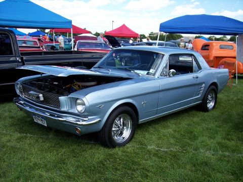1972 Ford Ranchero - A light blue 1965 Ford Mustang coupe is displayed with its hood open at a car show.