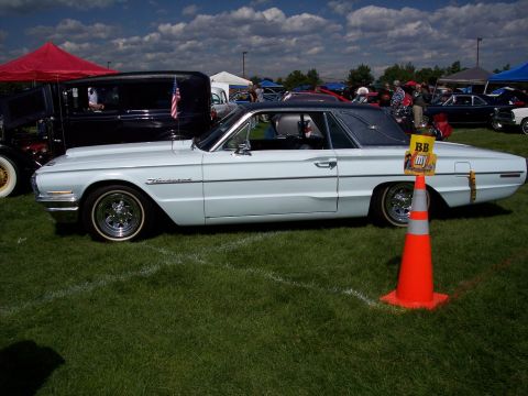 1972 Ford Ranchero - A light blue 1961 Ford Thunderbird is displayed on a grassy field at an outdoor car show.