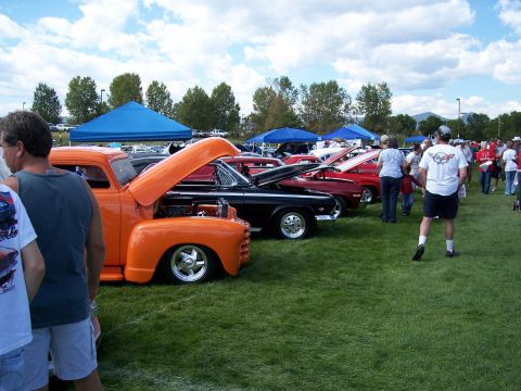 1972 Ford Ranchero - Several classic vehicles are displayed on a grassy field under a partly cloudy sky.