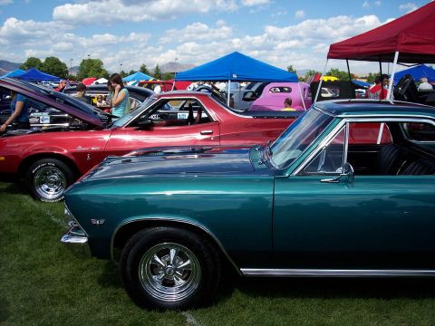 1972 Ford Ranchero - A red 1972 Ford Ranchero is displayed with its hood open at an outdoor car show, with other vehicles and tents in the background.