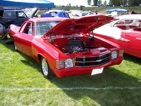 1972 Ford Ranchero - This red Chevrolet El Camino is on display at an outdoor car show with its hood up.