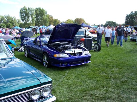 1972 Ford Ranchero - A purple convertible is displayed with its hood open at an outdoor car show.