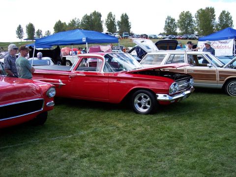 1972 Ford Ranchero - A red 1960 El Camino is displayed at an outdoor car show with other vehicles.