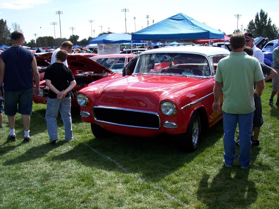 Red and white two-tone car, front view. Appears to be a 1955 model